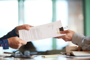 Home 8 closeup hands passing contract unrecognizable businessman