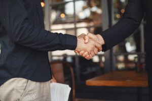 men shake hands enclosure business agreement understanding business partners 1